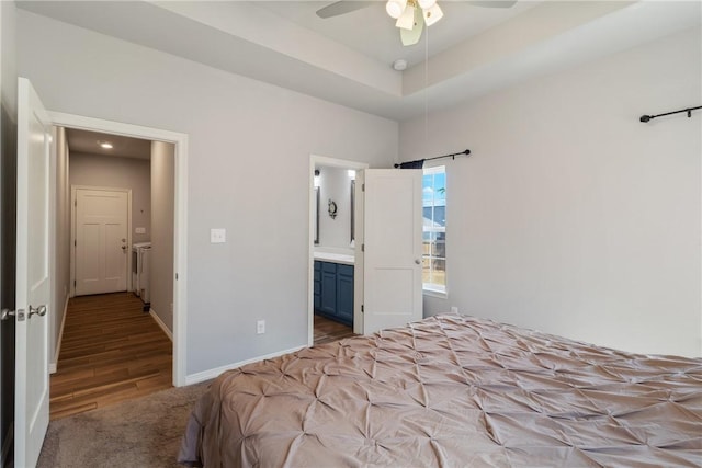 bedroom featuring ceiling fan, connected bathroom, and light hardwood / wood-style flooring