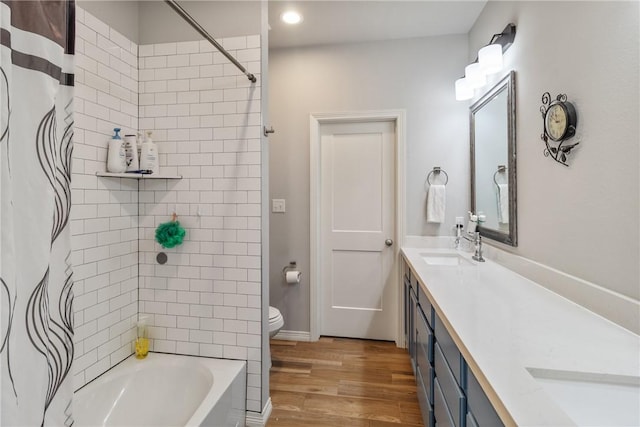 full bathroom featuring shower / tub combo with curtain, vanity, wood-type flooring, and toilet