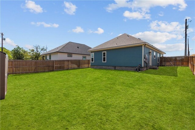 rear view of house with a lawn