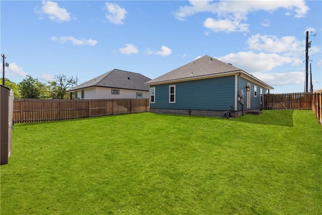 rear view of house with a yard