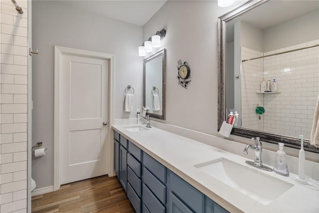 bathroom featuring vanity, hardwood / wood-style flooring, and toilet