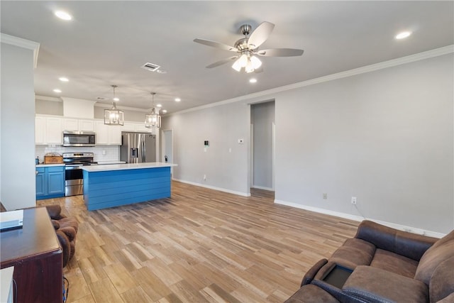 kitchen featuring stainless steel appliances, blue cabinetry, pendant lighting, light hardwood / wood-style flooring, and a kitchen island