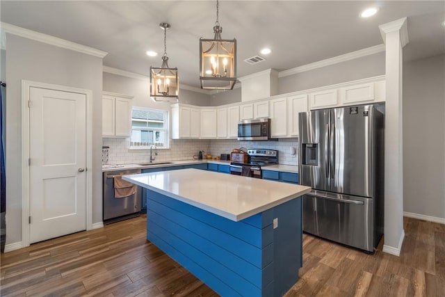 kitchen featuring a center island, dark wood-type flooring, sink, white cabinetry, and stainless steel appliances