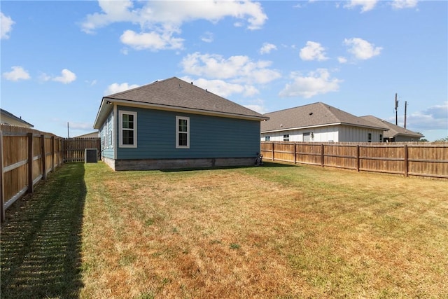 back of property with cooling unit and a yard