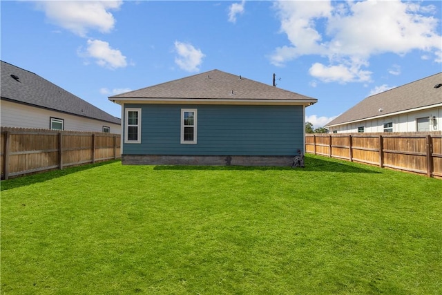 rear view of house featuring a yard