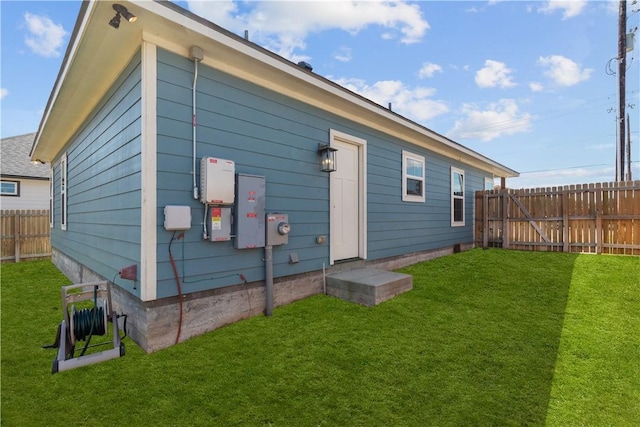 rear view of property featuring a lawn