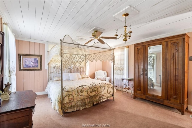 bedroom with carpet, ceiling fan, wooden walls, and wood ceiling