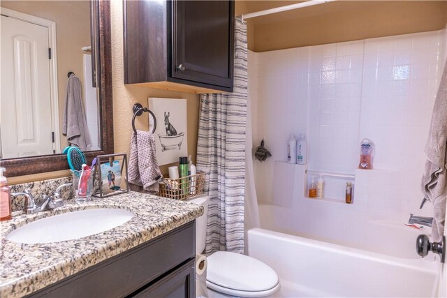 full bathroom with toilet, shower / tub combo, and vanity