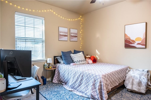 bedroom featuring ceiling fan and multiple windows