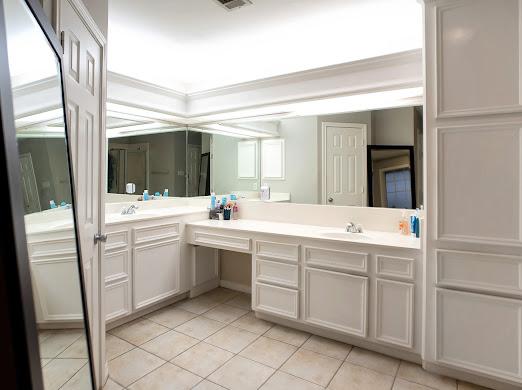 bathroom with tile patterned flooring, vanity, and ornamental molding