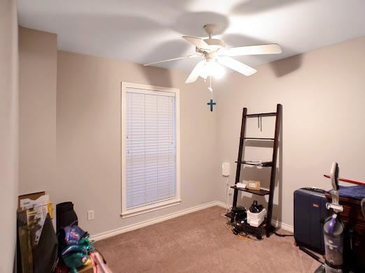 interior space with carpet flooring and ceiling fan