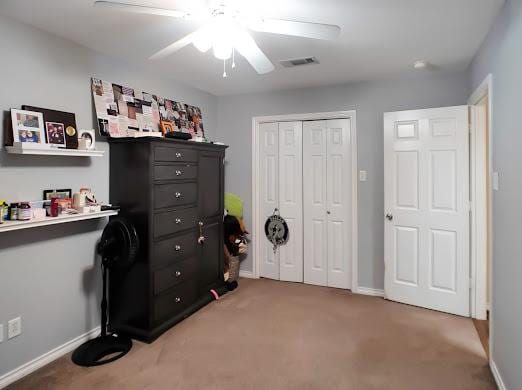 interior space featuring ceiling fan and carpet floors