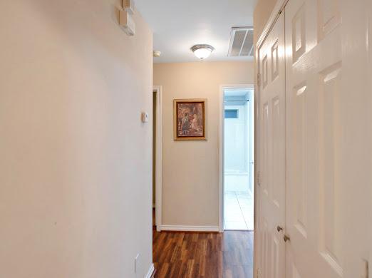 corridor featuring dark hardwood / wood-style flooring