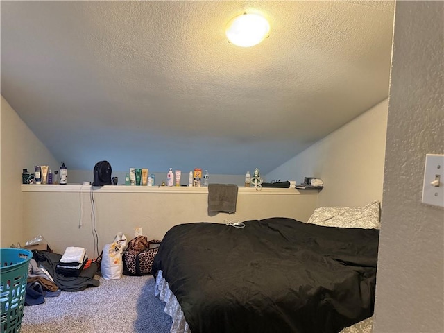 bedroom with carpet, a textured ceiling, and vaulted ceiling