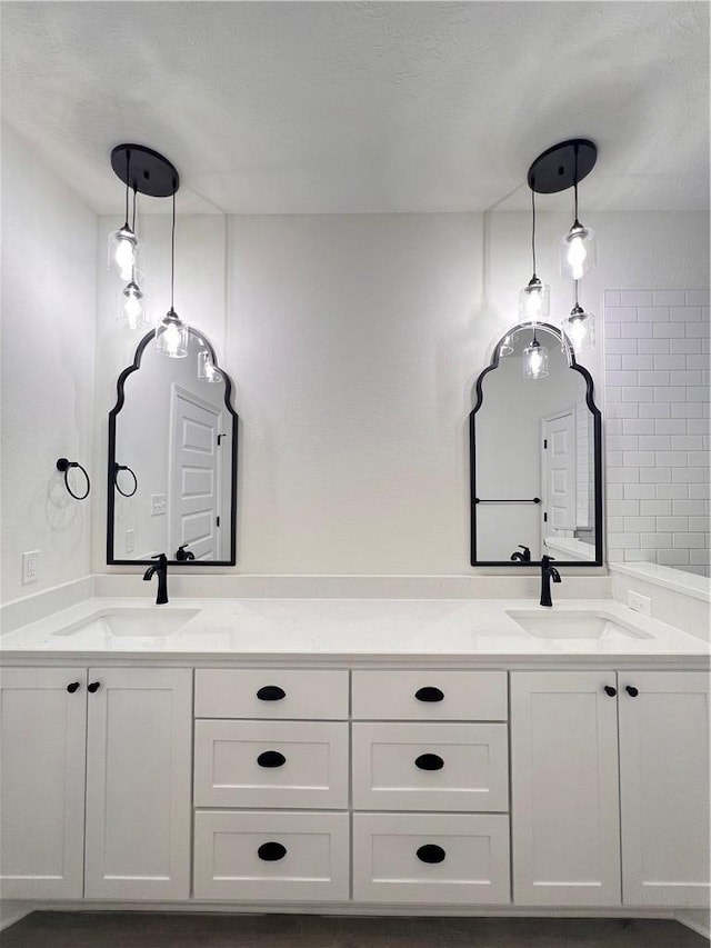 bathroom featuring a textured ceiling and vanity