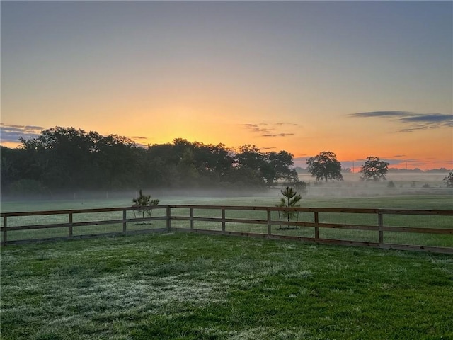 yard at dusk with a rural view