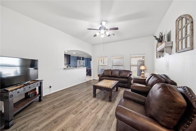 living room featuring ceiling fan and hardwood / wood-style flooring