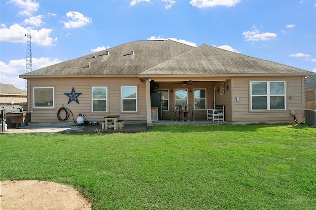 rear view of property featuring a patio area, ceiling fan, and a yard