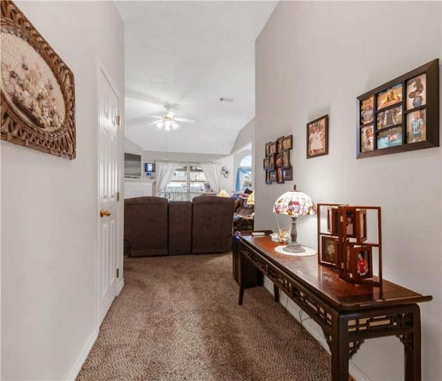 corridor with vaulted ceiling and carpet