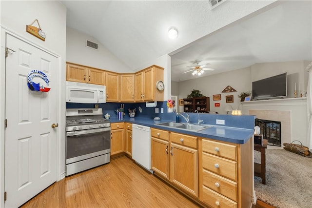 kitchen featuring lofted ceiling, sink, ceiling fan, kitchen peninsula, and white appliances