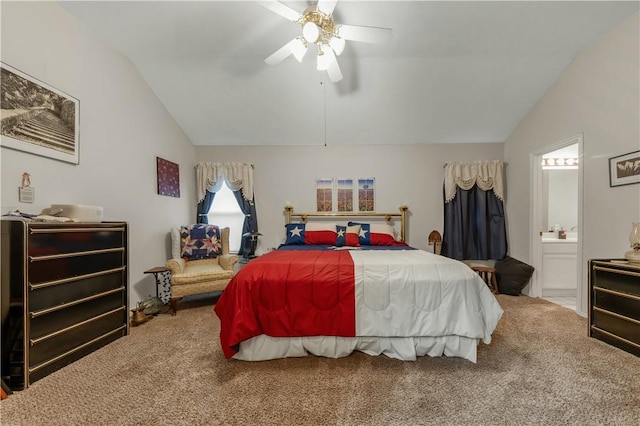 carpeted bedroom with vaulted ceiling, connected bathroom, and ceiling fan