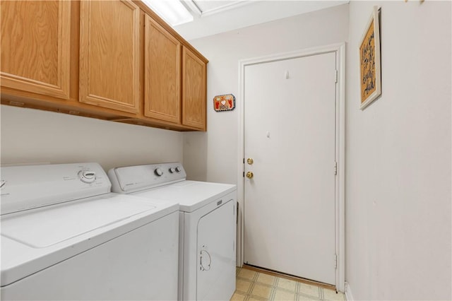 washroom with cabinets and washer and dryer