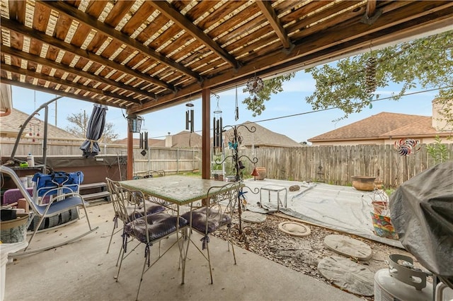 view of patio / terrace featuring area for grilling, a pergola, and a hot tub