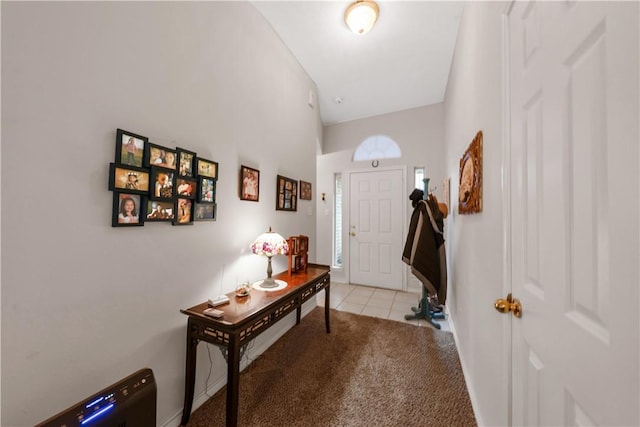 view of carpeted foyer entrance