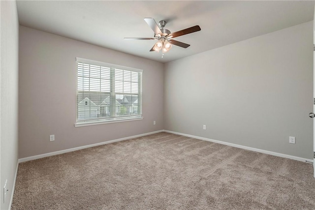 unfurnished room with carpet, ceiling fan, and baseboards