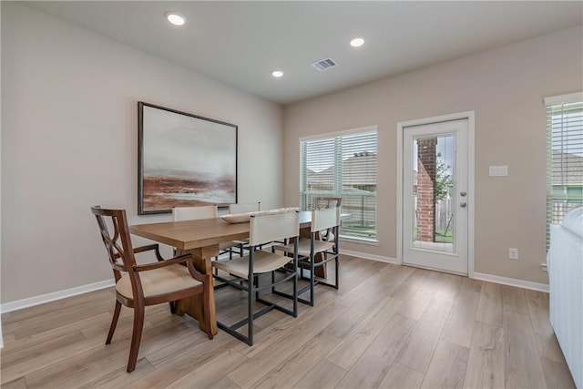 dining area with a healthy amount of sunlight, light wood-style floors, and visible vents