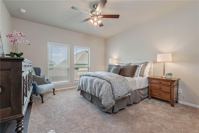 bedroom featuring light carpet, ceiling fan, and baseboards