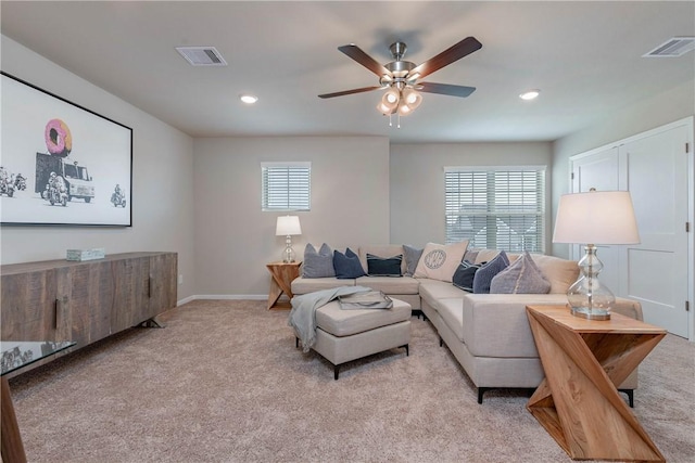 living area with a ceiling fan, light colored carpet, visible vents, and recessed lighting