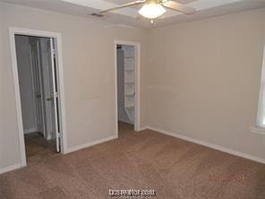 unfurnished bedroom featuring carpet floors, a ceiling fan, and baseboards