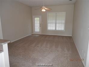 unfurnished living room featuring baseboards, a ceiling fan, and carpet flooring