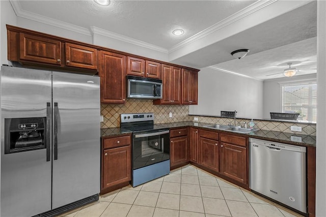 kitchen featuring a sink, decorative backsplash, appliances with stainless steel finishes, and light tile patterned floors