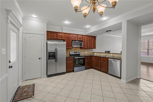 kitchen with light tile patterned floors, ornamental molding, stainless steel appliances, a notable chandelier, and backsplash