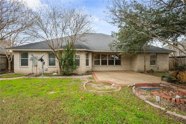 rear view of house with a patio area and a lawn