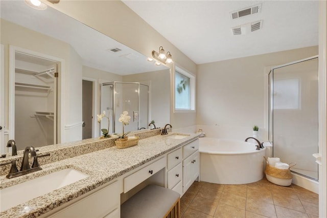 bathroom with separate shower and tub, tile patterned flooring, and vanity