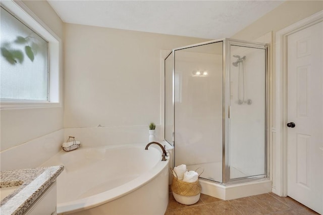 bathroom with tile patterned floors, vanity, and independent shower and bath