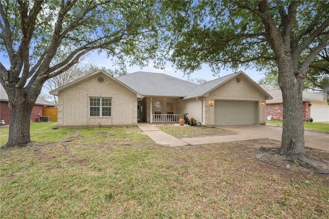 ranch-style house featuring a front lawn, a porch, and a garage