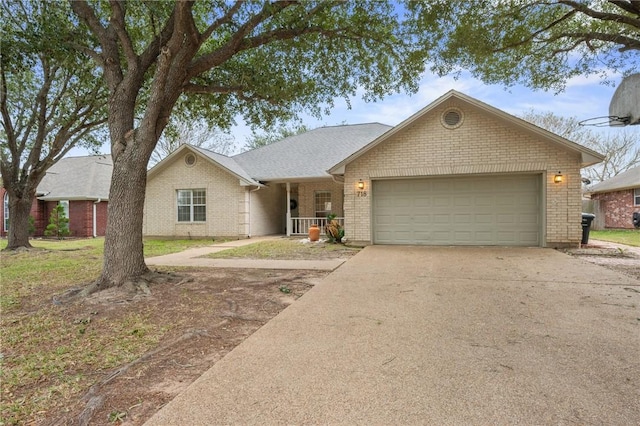 ranch-style home with a porch and a garage