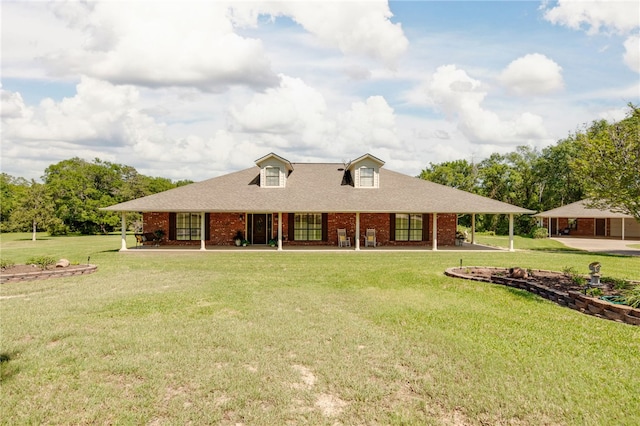 farmhouse with brick siding, a shingled roof, and a front lawn