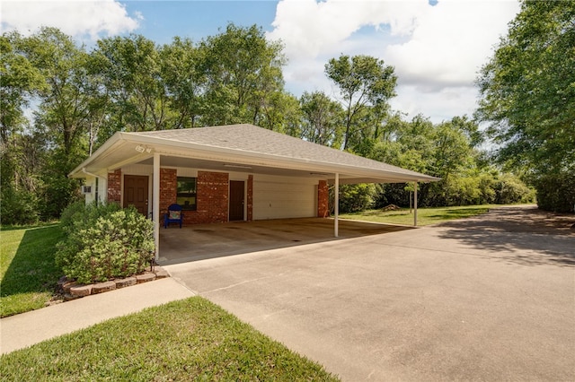 view of community with a lawn, an attached garage, driveway, and an attached carport