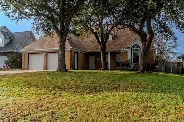 view of property featuring a garage, central air condition unit, and a front yard