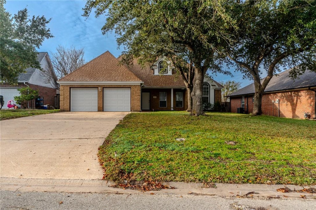 view of front of property with a front lawn and a garage