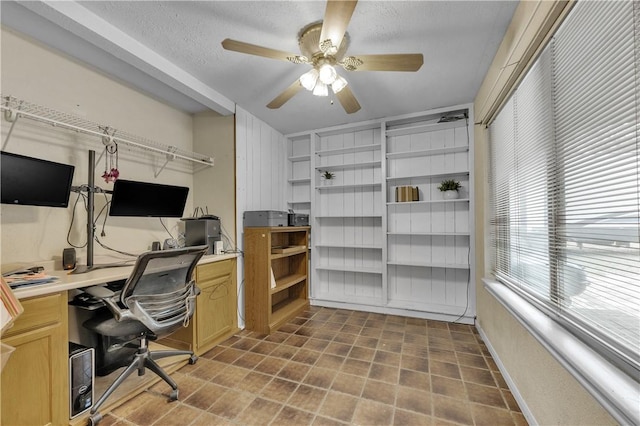 office with a textured ceiling and ceiling fan