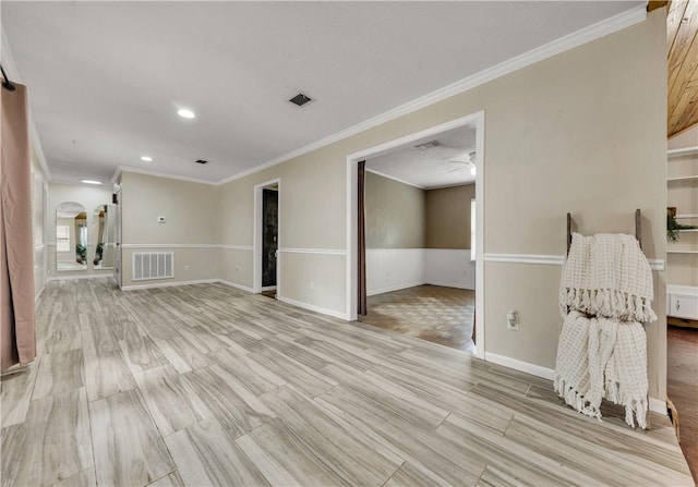 spare room featuring ceiling fan, light hardwood / wood-style flooring, and ornamental molding