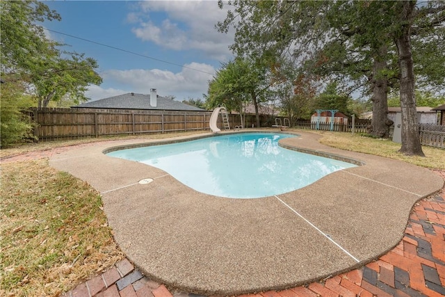 view of swimming pool with a patio area and a water slide