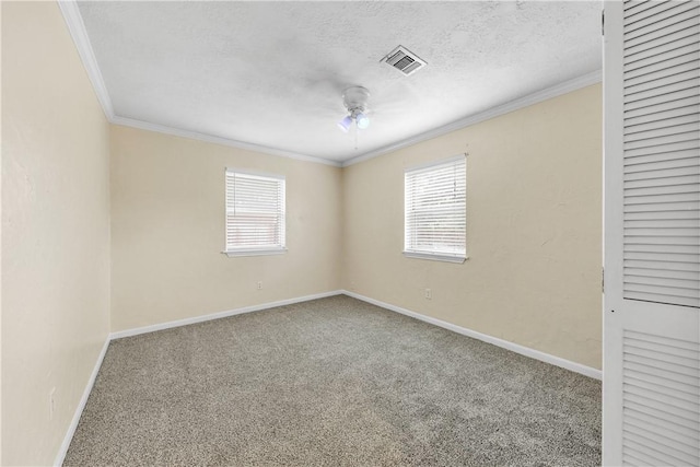 unfurnished room featuring carpet, plenty of natural light, and crown molding