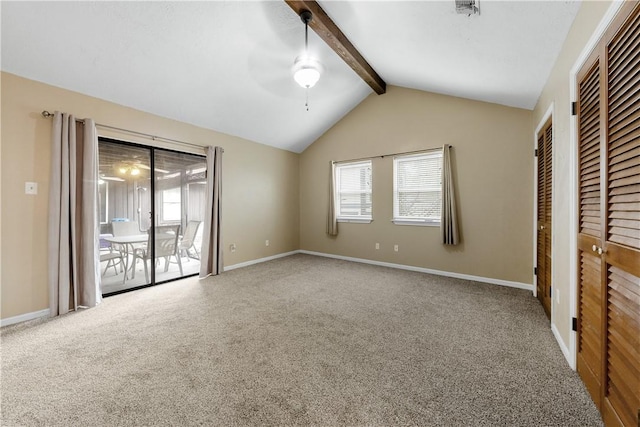 unfurnished bedroom featuring carpet flooring, multiple windows, and lofted ceiling with beams